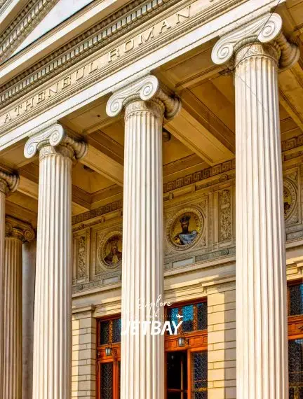 Neoclassical columns and ornate facade of historic Bucharest building showcasing Romanian architectural heritage