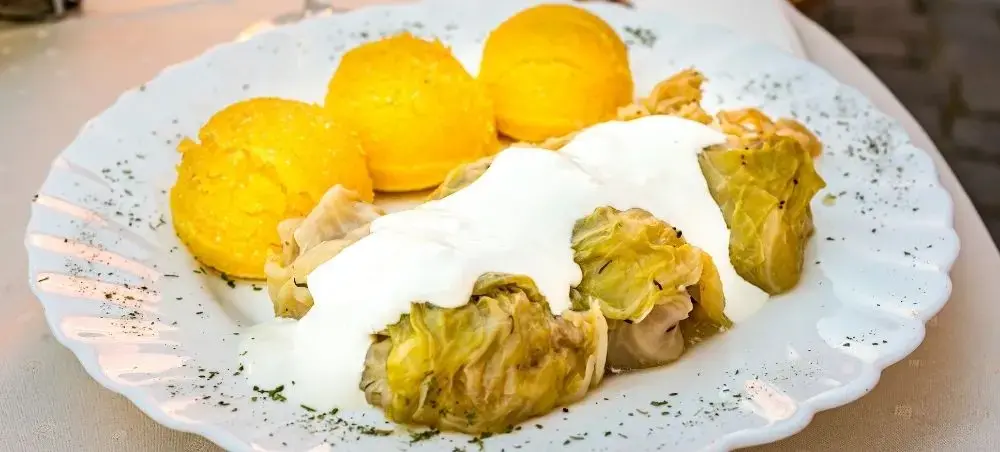 Traditional Romanian cabbage rolls with sour cream and polenta showcasing authentic Bucharest cuisine