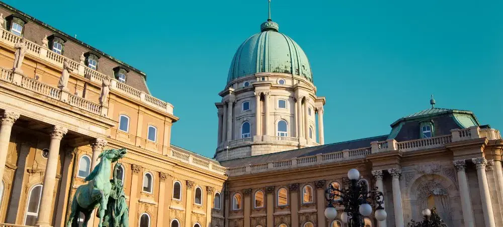 Historic Buda Castle complex with baroque architecture and green copper dome in Budapest, Hungary
