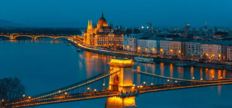 Budapest skyline at twilight featuring illuminated Chain Bridge and Hungarian Parliament building along Danube River