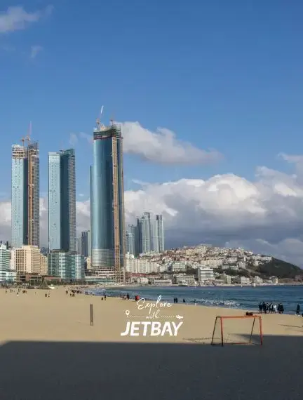 Modern skyscrapers rise above Haeundae Beach in Busan, showcasing South Korea's coastal luxury destination