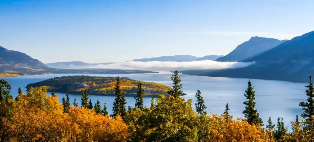 Stunning autumn landscape showcasing Canada's pristine wilderness with golden foliage and mountain lakes