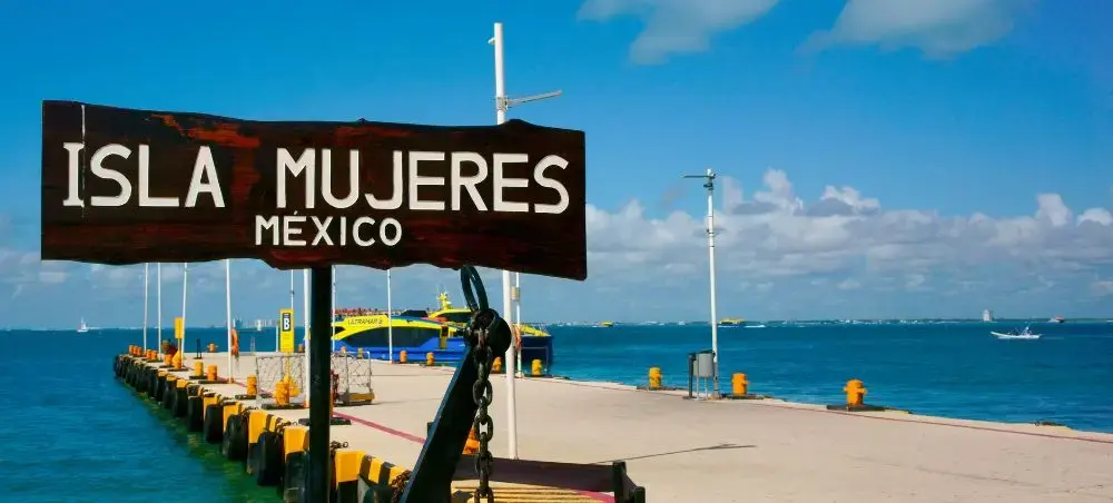Isla Mujeres ferry dock with turquoise Caribbean waters showcasing luxury travel destination near Cancun