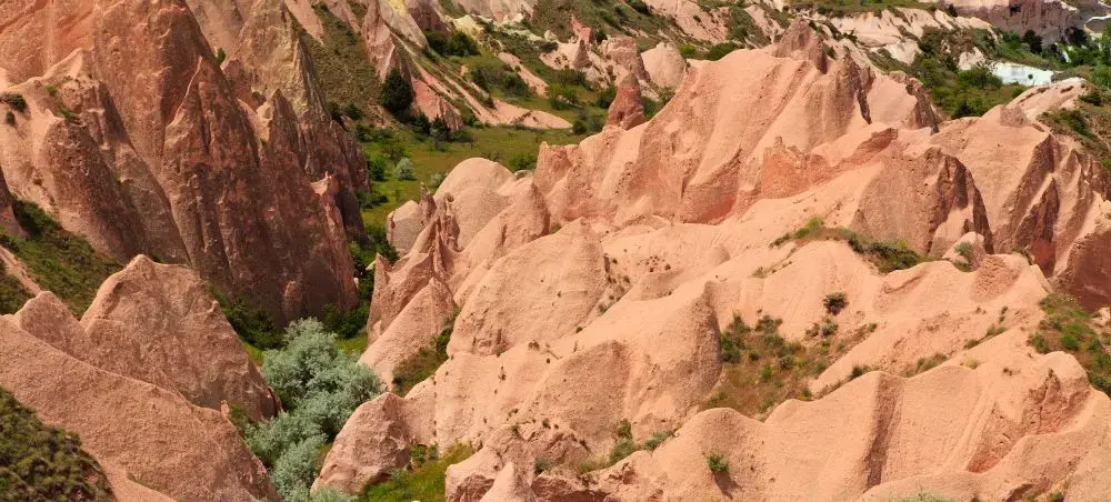Aerial view of Cappadocia's distinctive fairy chimney rock formations and valleys in warm sandstone hues