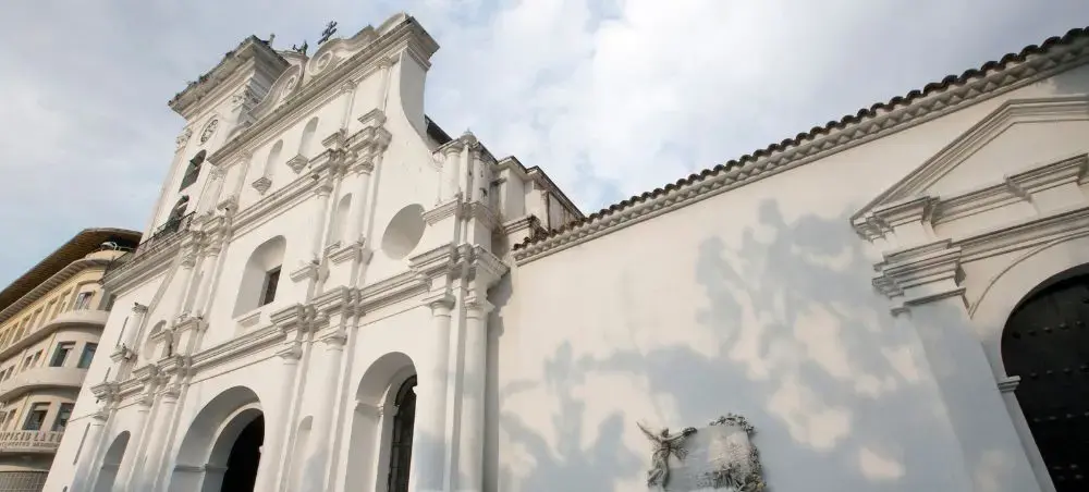 Historic white colonial cathedral with ornate baroque facade and twin bell towers in Caracas Venezuela