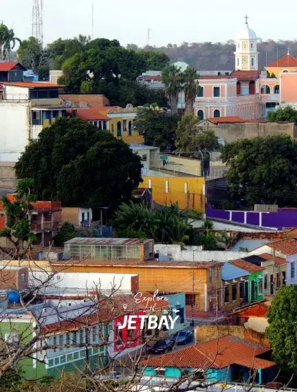Colorful colonial buildings and church tower showcase Caracas Venezuela's historic architecture for luxury travel with Jetbay
