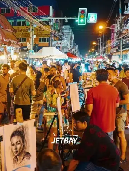 Bustling Chiang Mai night market with street artists creating portraits and crowds exploring local vendors