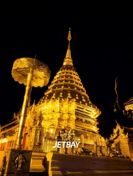 Golden illuminated Wat Phra That Doi Suthep temple pagoda at night in Chiang Mai, Thailand