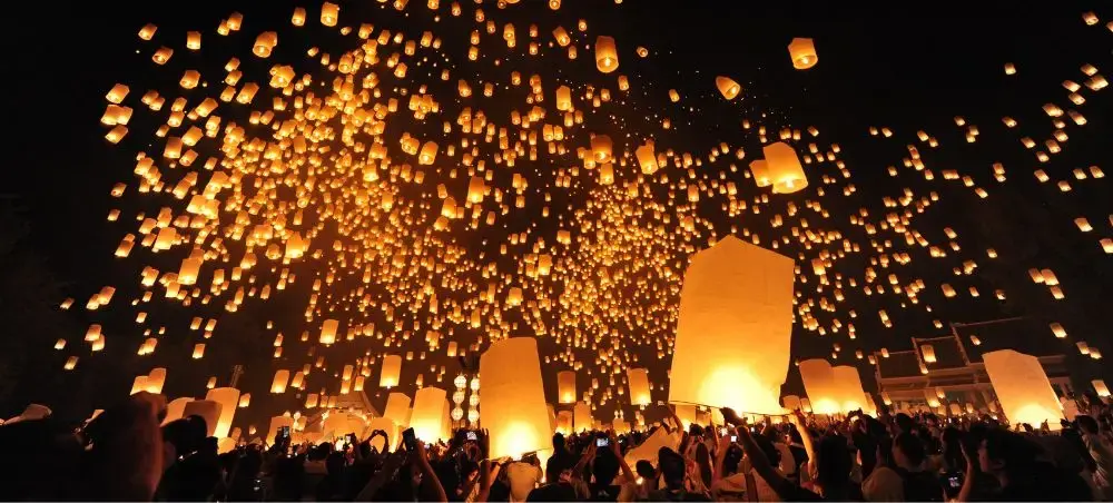Thousands of glowing paper lanterns illuminate the night sky during Chiang Mai's magical Yi Peng festival