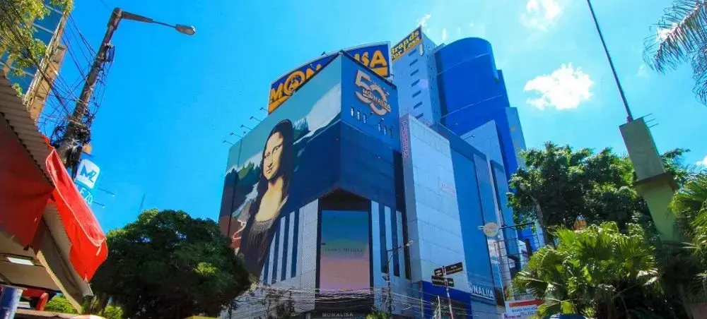 Modern shopping center with colorful Mona Lisa mural in Ciudad del Este's bustling commercial district