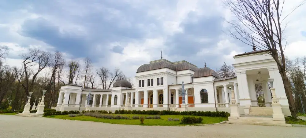 Elegant neoclassical palace with white columns and domed roofs in Cluj-Napoca, Romania's cultural center