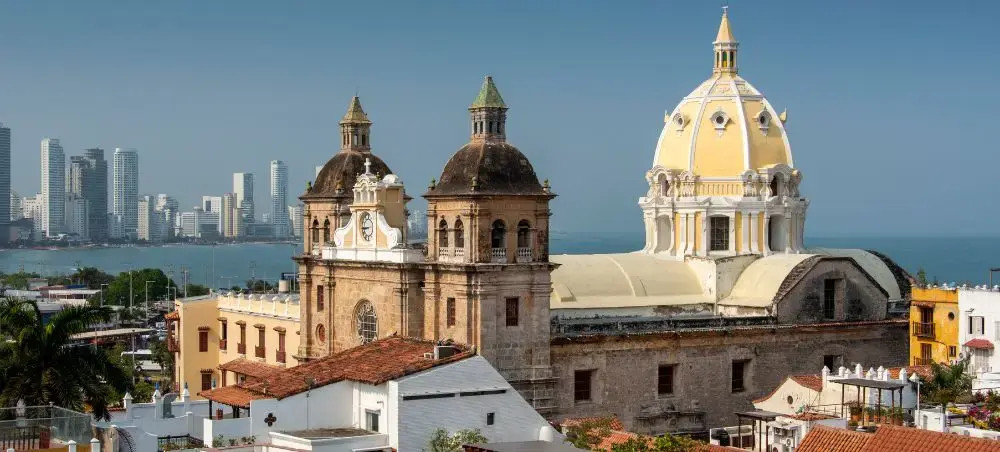 Historic colonial cathedral with distinctive domes overlooking Cartagena's old town and modern skyline