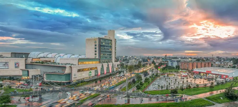 Modern Colombian cityscape at sunset with busy highways and contemporary architecture showcasing urban development
