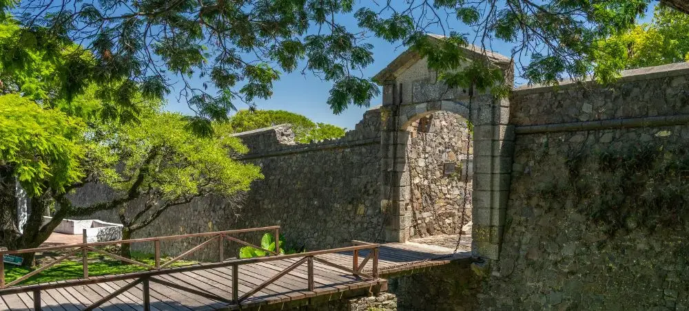 Historic stone fortifications and wooden walkway in Colonia del Sacramento's UNESCO World Heritage quarter