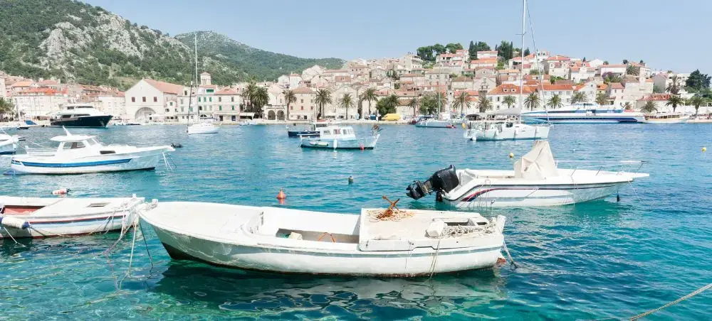Traditional fishing boats anchored in crystal-clear waters of a picturesque Croatian coastal town