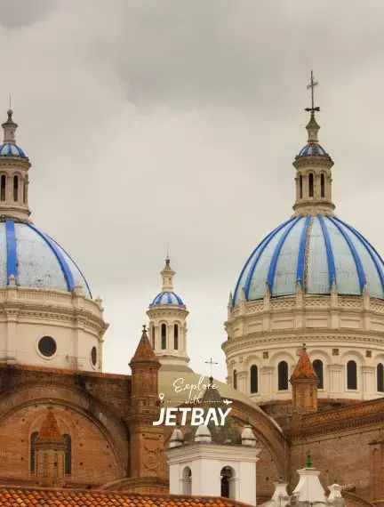 Historic blue-domed cathedral towers rising above Cuenca's colonial architecture in Ecuador's cultural capital