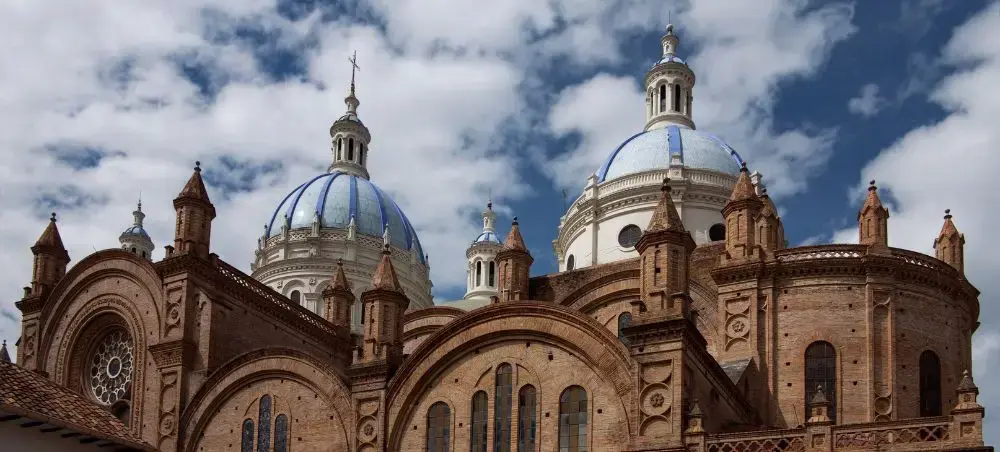 Cuenca Cathedral's distinctive blue domes and red brick towers showcase Ecuador's colonial architecture