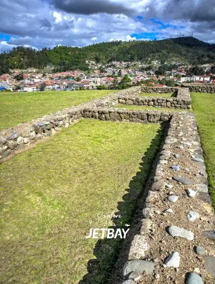 Ancient Incan ruins at Ingapirca archaeological site near Cuenca with Andean mountains and colonial town