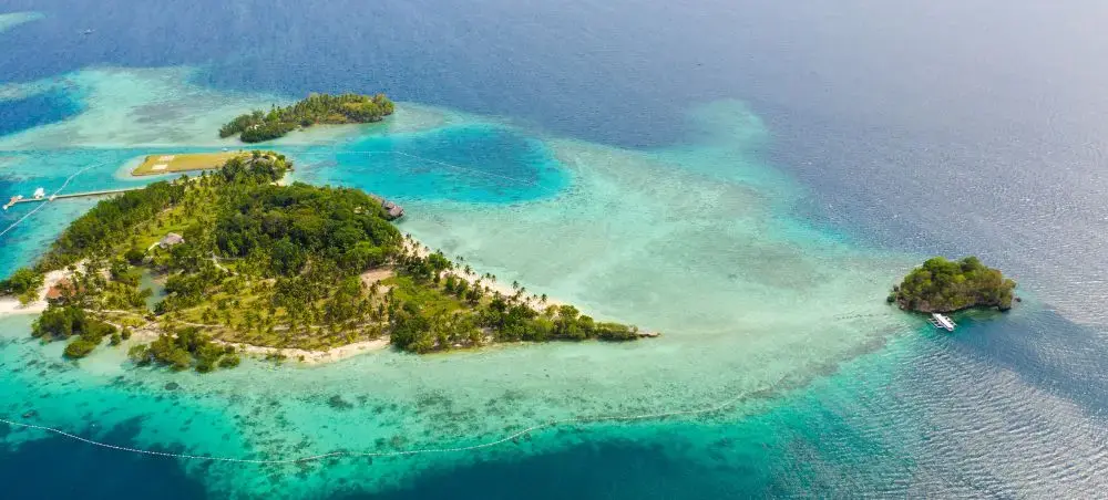 Aerial view of tropical islands with turquoise lagoons and coral reefs near Davao City, Philippines