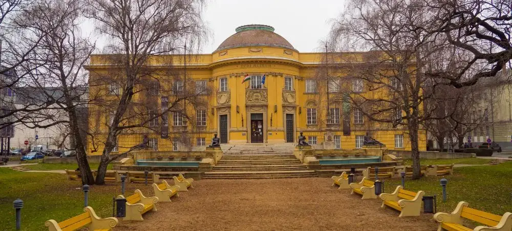 Historic yellow neoclassical building with dome and columns in Debrecen city center, Hungary