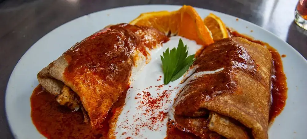 Traditional Hungarian crepes filled with savory ingredients and rich sauce, showcasing Debrecen's culinary heritage