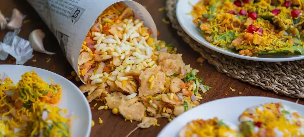 Authentic Delhi street food featuring spiced rice dishes and traditional Indian snacks served on rustic plates
