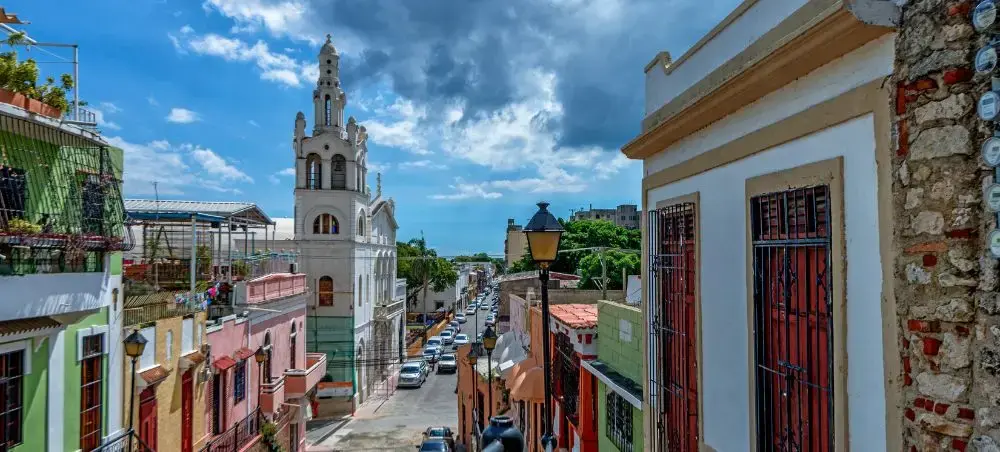 Colorful colonial buildings and historic church tower in Dominican Republic's charming old town streets