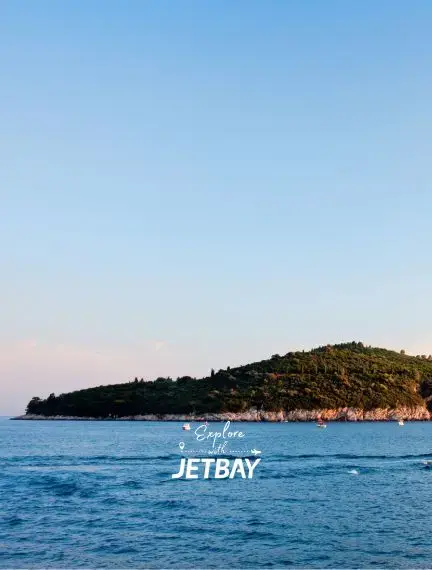 Pristine Adriatic waters surrounding forested Croatian coastline near Dubrovnik for luxury travel