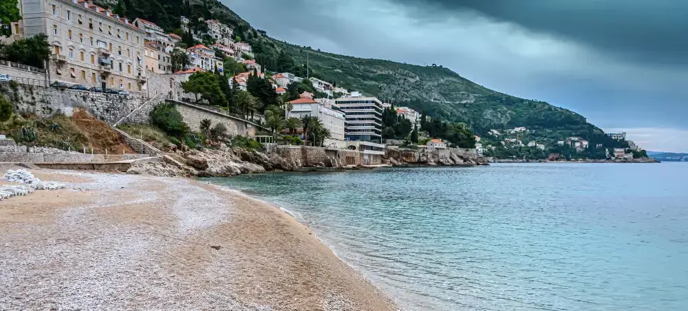 Pristine Adriatic coastline near Dubrovnik with luxury hotels cascading down hillsides to crystal-clear waters
