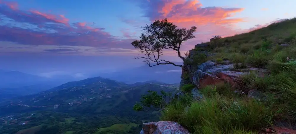 Dramatic sunset over rolling green mountains near Durban showcasing South Africa's stunning landscapes