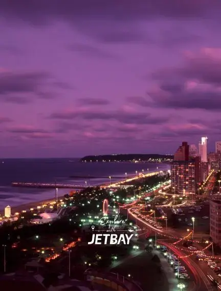 Durban's golden beachfront and illuminated skyline at twilight showcasing South Africa's coastal luxury
