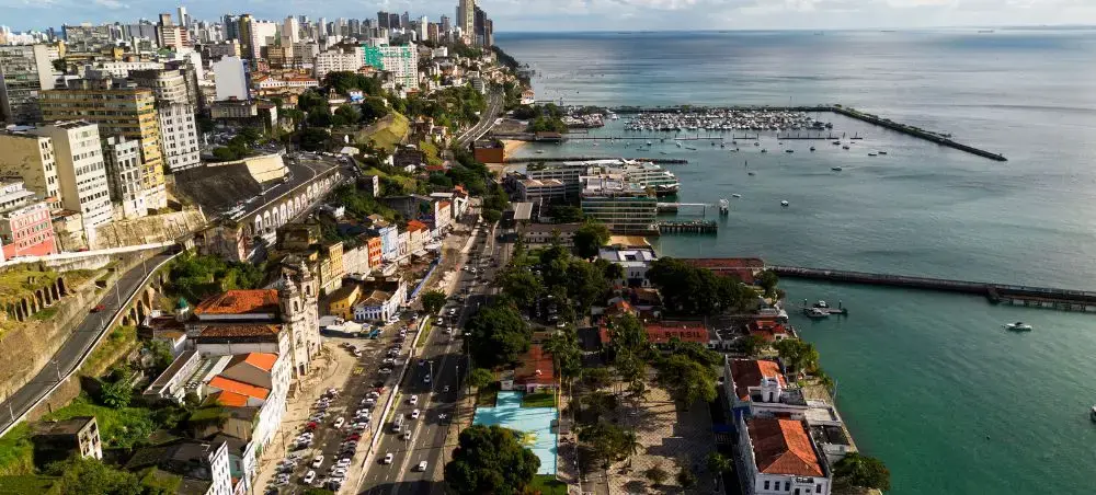 Aerial view of Salvador's historic coastline with colonial buildings, marina, and turquoise waters