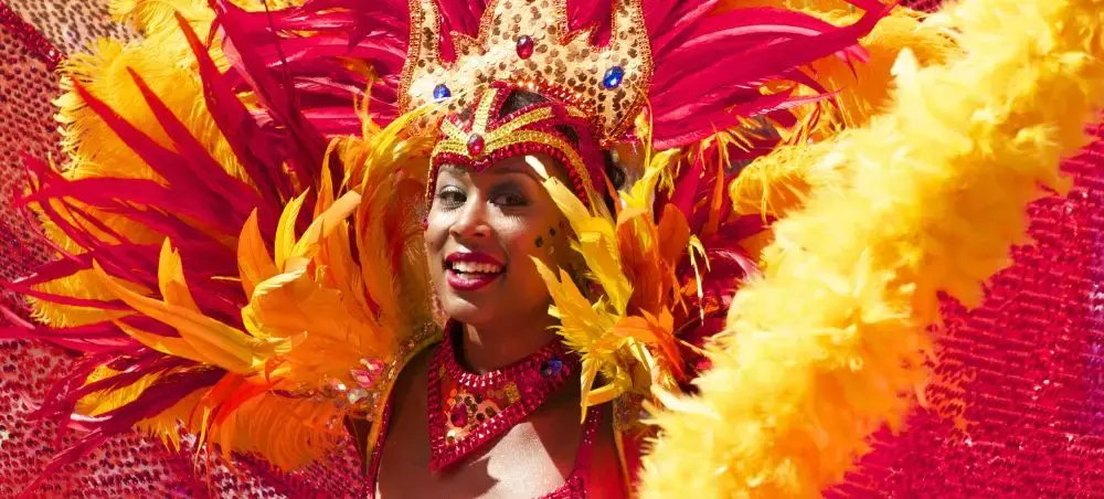 Vibrant carnival dancer in elaborate feathered costume celebrating at Encarnacion's famous festival