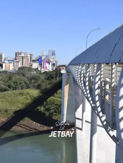Modern pedestrian bridge overlooking Encarnacion cityscape and Parana River in Paraguay