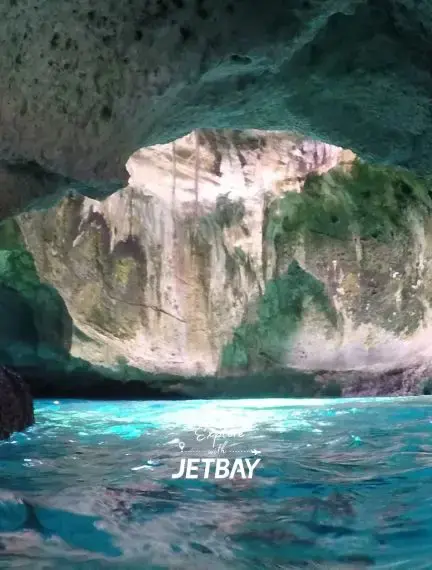 Stunning limestone cave formation with crystal-clear turquoise waters in Exuma, Bahamas for luxury travel