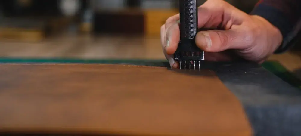 Skilled artisan hand-crafting premium leather goods in Florence workshop, showcasing traditional Italian craftsmanship