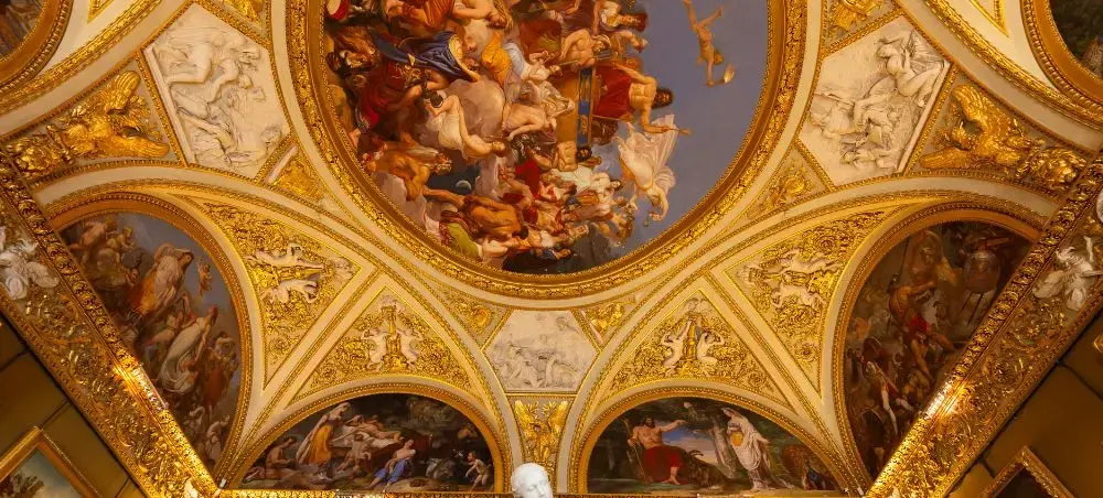 Ornate Renaissance frescoes and golden decorative ceiling inside historic Florentine palace or museum