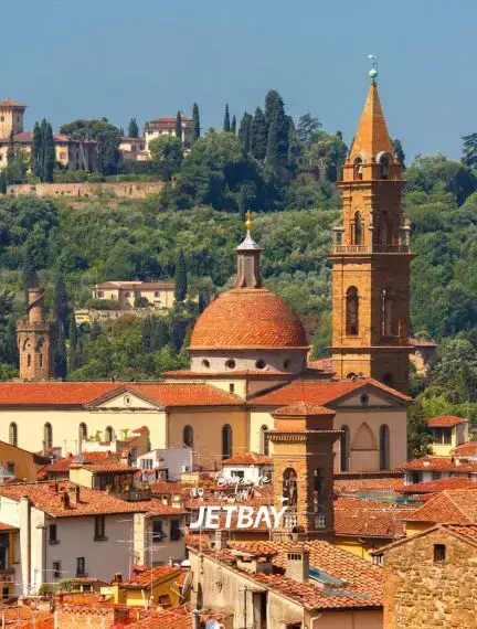 Historic Florence skyline featuring Renaissance church dome and bell tower with hillside villas beyond