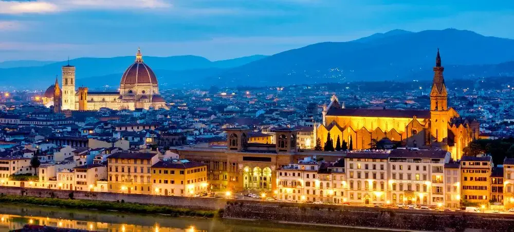 Florence skyline at twilight featuring the iconic Duomo cathedral and Santa Croce basilica illuminated