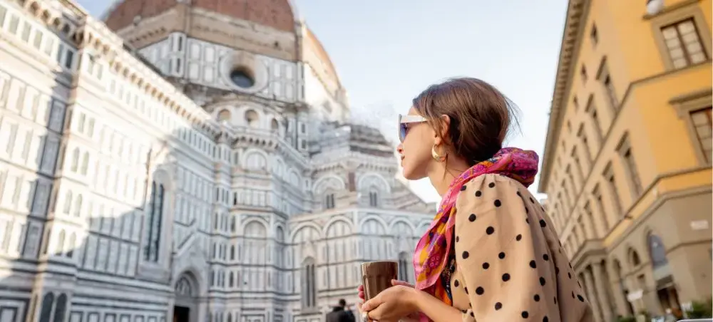 Stylish traveler admiring Florence Cathedral's iconic Renaissance dome and marble facade architecture