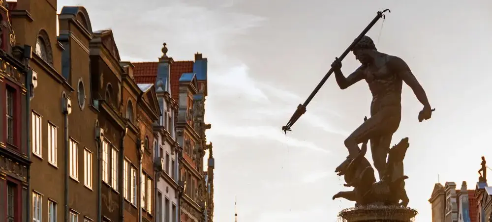 Neptune fountain statue dominates Gdansk's historic Long Market square surrounded by colorful merchant houses