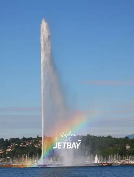 Geneva's iconic Jet d'Eau fountain shooting water 140 meters high with rainbow mist over Lake Geneva