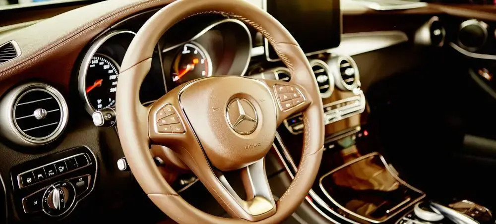 Luxury Mercedes-Benz interior with leather steering wheel and premium dashboard for executive ground transportation in Germany