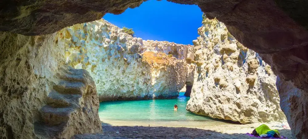 Secluded turquoise lagoon framed by dramatic limestone cliffs in Greece, perfect for luxury travel