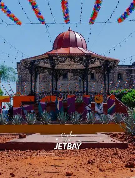 Historic Guadalajara bandstand with ornate dome and colorful papel picado decorations in town square