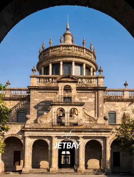 Historic Guadalajara cathedral with ornate baroque architecture and twin spires under clear blue sky