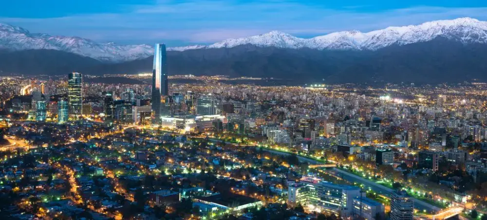 Guadalajara skyline illuminated at twilight with snow-capped mountains backdrop showcasing Mexico's vibrant city