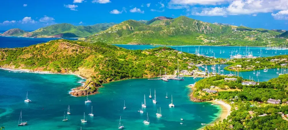 Pristine Caribbean coastline of Guatemala with turquoise waters, luxury yachts, and lush tropical mountains