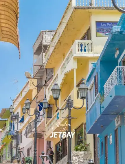 Colorful colonial buildings with ornate balconies line historic Las Peñas neighborhood in Guayaquil, Ecuador