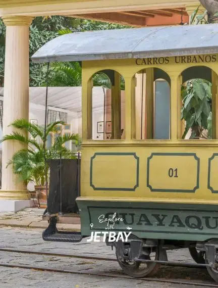 Historic yellow trolley car on cobblestone street in Guayaquil showcasing traditional Ecuadorian transportation